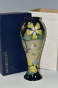 A BOXED MOORCROFT POTTERY 'HYPERICUM' PATTERN VASE, of slender inverted baluster form and flared