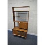 A MID CENTURY TEAK G PLAN EGOMME ROOM DIVIDER, with four shelves, two fall front cupboard doors