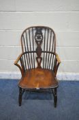 A 19TH CENTURY ELM WINDSOR CARVER CHAIR, with a spindle back and central star design (condition