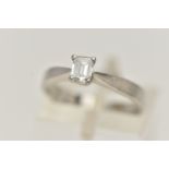 A PLATINUM SINGLE STONE DIAMOND RING, emerald cut diamond prong set in platinum, leading on to a