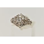 A WHITE METAL ABSTRACT DIAMOND RING, raised marquise shape, set with a central round brilliant cut