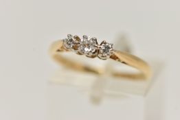 A THREE STONE DIAMOND RING, three old cut diamonds, prong set in white metal, leading on to a yellow