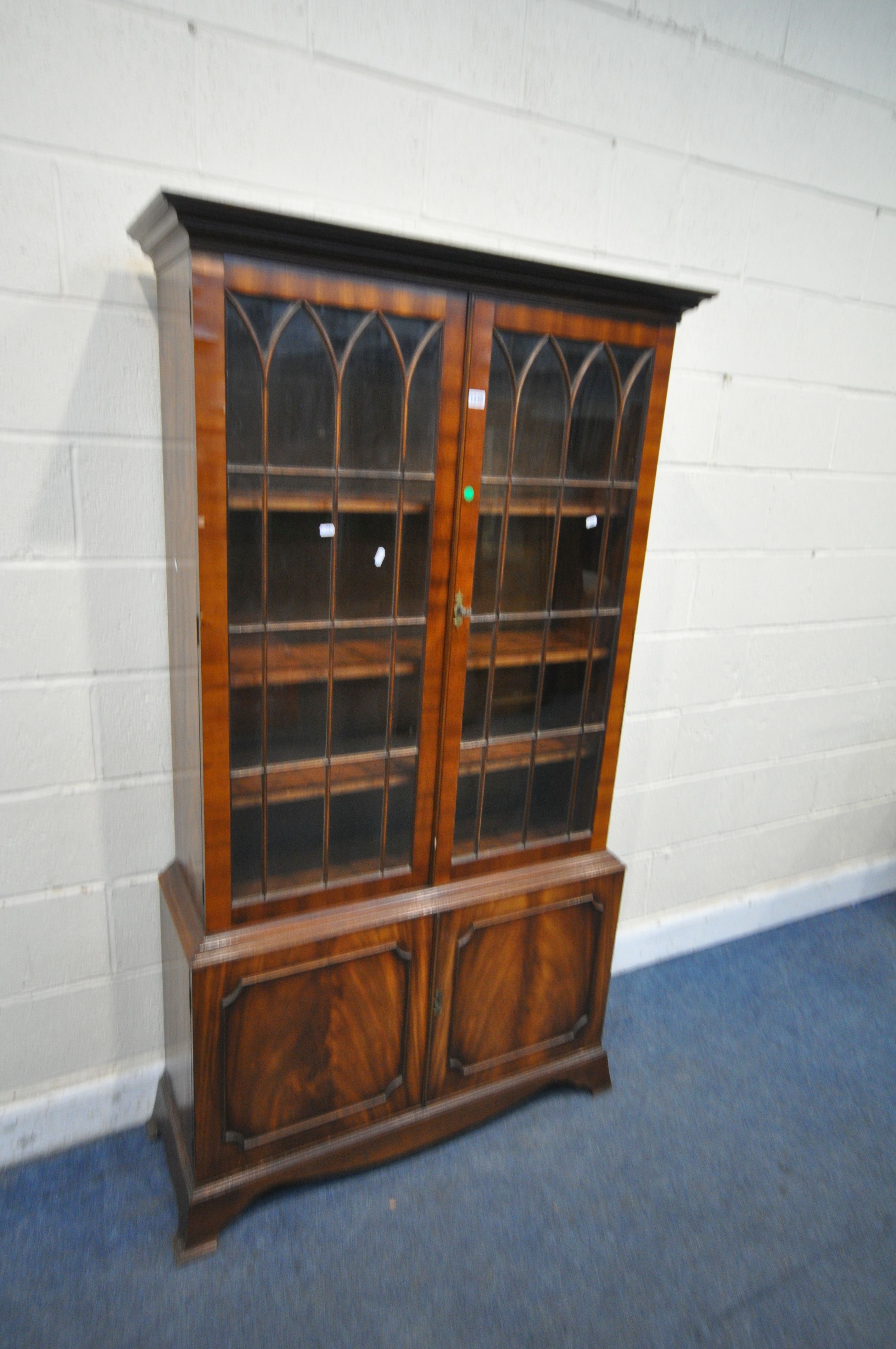 A BEVAN FUNNELL MAHOGANY BOOKCASE, with two glazed doors and two cupboard doors, width 106cm x depth
