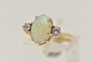 A YELLOW METAL OPAL AND DIAMOND RING, centring on an oval cut opal cabochon, in a nine claw setting,