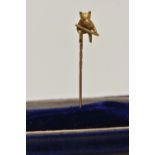 A YELLOW METAL STICK PIN, set with a bear holding a stick, unmarked, length 42mm, approximate