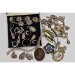 AN ASSORTMENT OF WHITE METAL JEWELLERY, to include two Scottish brooches, a charm bracelet fitted