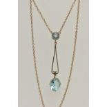 AN EARLY 20TH CENTURY YELLOW METAL PENDANT NECKLACE, the drop pendant set with a pale blue oval