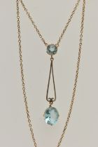 AN EARLY 20TH CENTURY YELLOW METAL PENDANT NECKLACE, the drop pendant set with a pale blue oval