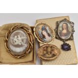 FIVE BROOCHES, to include a large gold plated swivel mourning brooch, one side set with a carved