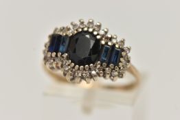 A 9CT GOLD DIAMOND AND SAPPHIRE CLUSTER RING, oval and baguette cut sapphires set with a surround of