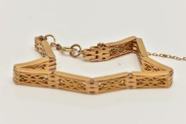 A YELLOW METAL ARTICULATED BRACELET, designed as a series of open work rectangular links, fitted