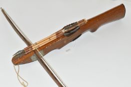 A SMALL CROSSBOW, in working order complete with four arrows, the stock is engraved Philippines
