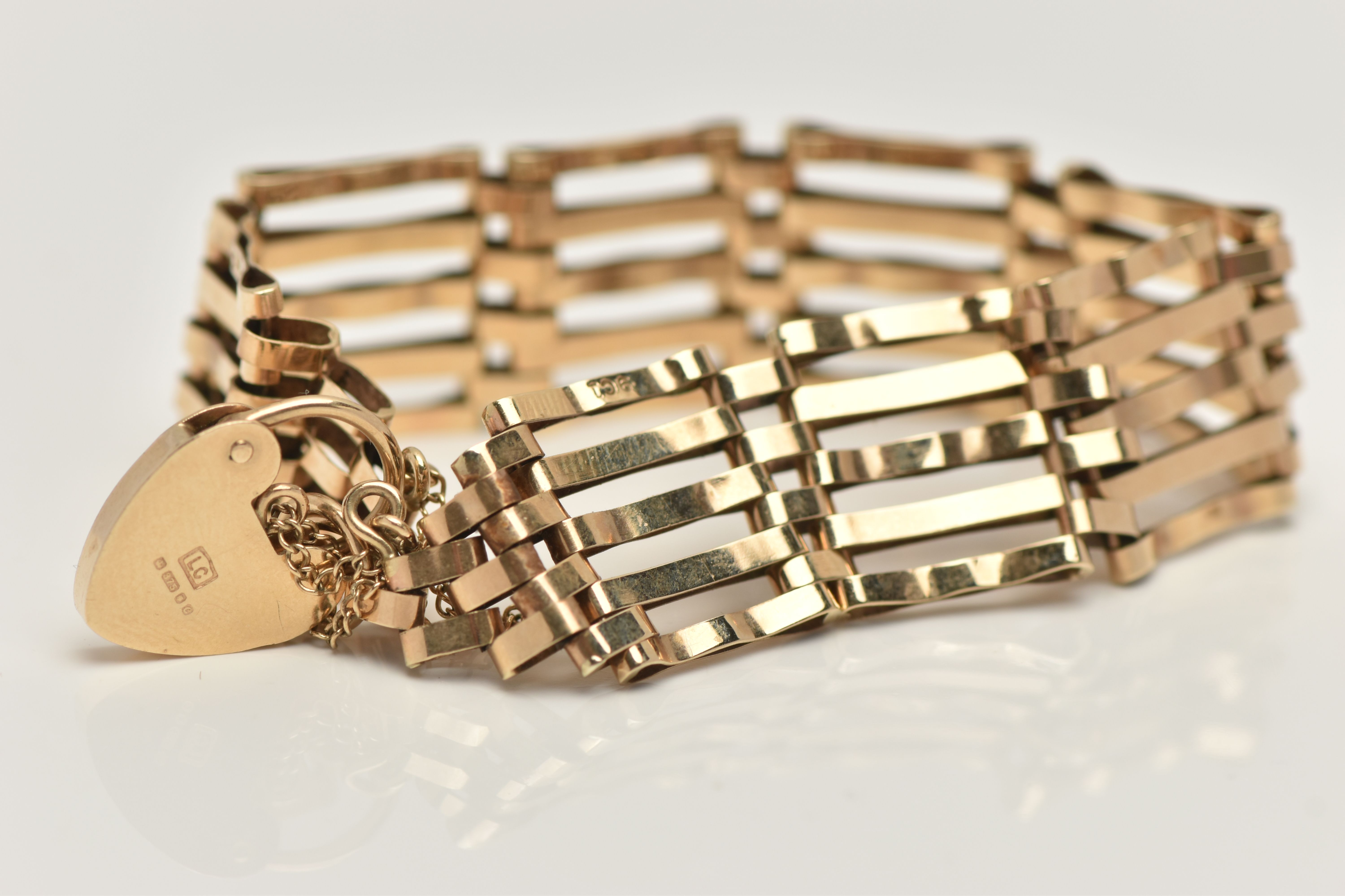 A 9CT GOLD GATE BRACELET, five bar gate bracelet, stamped 9ct, fitted with a heart padlock clasp, - Image 2 of 2