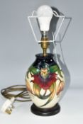 A MOORCROFT POTTERY 'ANNA LILY' TABLE LAMP, the baluster lamp tube-lined with deep red and orange