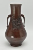 A JAPANESE MEIJI PERIOD PATINATED BRONZE TWIN HANDLED VASE OF BALUSTER FORM, cast in relief with