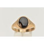 A 9CT GOLD SIGNET RING, of an oval form, set with a polished onyx inlay (AF chipped), to a