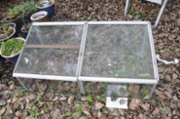 A GLASS AND ALUMINIUM GARDEN CLOCHE with two hinged doors to top width 130cm depth 68cm height 48cm