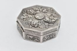 AN ORIENTAL OCTAGONAL WHITE METAL TRINKET BOX, hinged lid, the exterior repoussé decorated and