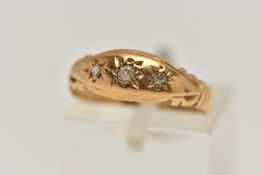AN EARLY 20TH CENTURY 18CT GOLD DIAMOND RING, designed with three star set diamonds, scroll