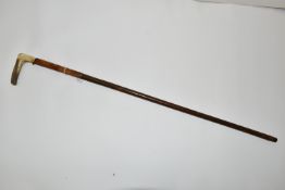 AN ANTIQUE 7MM CENTREFIRE WALKING STICK SHOTGUN IN WORKING ORDER, its handle is made from a deer's