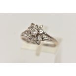 A WHITE METAL DIAMOND CLUSTER RING, of a flower shape, set with a central round brilliant cut