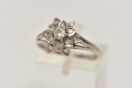 A WHITE METAL DIAMOND CLUSTER RING, of a flower shape, set with a central round brilliant cut