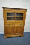 A SOLID OAK CABINET, with two glazed doors, above and single drawer and two cupboard doors, width