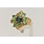 A 9CT GOLD GEM SET RING, dress ring set with a central oval cut green sapphire, within a surround of