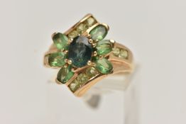 A 9CT GOLD GEM SET RING, dress ring set with a central oval cut green sapphire, within a surround of