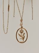AN EARLY 20TH CENTURY NECKLACE, an open work floral pendant, set with seed pearls, suspended from an