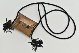 AN ART DECO STYLE BRASS CUSHION SHAPED EVENING PURSE, on a tasselled black cord, lined interior,