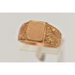 A YELLOW METAL SIGNET RING, polished rectangular signet to scrolling floral shoulders and polished