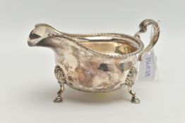 A MID 20TH CENTURY SILVER GRAVY BOAT, polished form, gadrooned rim, on three cabriolet legs,
