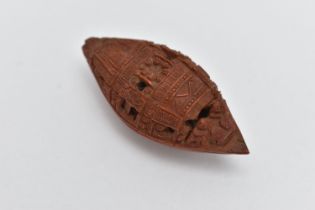 A CHINESE HEDIAO NUT CARVED AS A BOAT, inscribed verso with Chinese script / poem, Qing period,