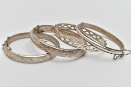FOUR SILVER HINGED BANGLES, to include two hollow hinged bangles, engraved with foliage detail, a