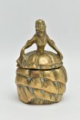 AN EARLY 20TH CENTURY BRASS INKWELL IN THE FORM OF A CRINOLINE LADY, with hinged skirt, the interior