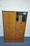 A MID CENTURY TEAK GENTLEMAN'S WARDROBE, with two doors, two mirrored sliding doors, a fall front