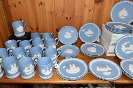 A LARGE QUANTITY OF CHRISTMAS WEDGWOOD BLUE JASPERWARE TANKARDS AND PLATES, comprising fifteen