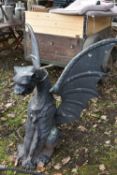 A HEAVY CAST IRON GARDEN SCULPTURE, of a mythical dragon with outspread wings, width 103cm x depth
