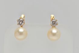 A PAIR OF YELLOW METAL EARRINGS, each earring set with an imitation pearl and a circular cut cubic