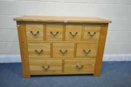 A SOLID OAK SIDEBOARD, with nine assorted drawers, length 120cm x depth 49cm x height 85cm (