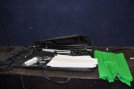 A BAG CONTAINING PHOTOGRAPHIC GREEN, WHITE AND BLACK SCREENS, four stands, a tripod and a reflector
