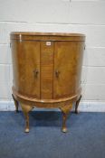 A NORTHAMPTON CABINET COMPANY BURR WALNUT DEMI LUNE CABINET, the two cupboard doors, enclosing a
