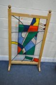 A LEAD GLAZED ABSTRACT STAINED GLASS PANEL, in a bespoke ash frame, width 76cm x depth 36cm x height