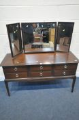 A STAG MINSTREL DRESSING TABLE, with triple mirror and six drawers, length 131cm x depth 47cm x