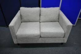 AN OATMEAL UPHOLSTERED TWO SEATER SOFA, length 136cm x depth 91cm x height 70cm (condition report: