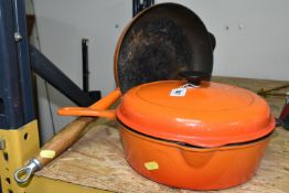 TWO LE CREUSET VOLCANO ORANGE COLOURED PANS, comprising a lidded size 27 pan (lid has a small