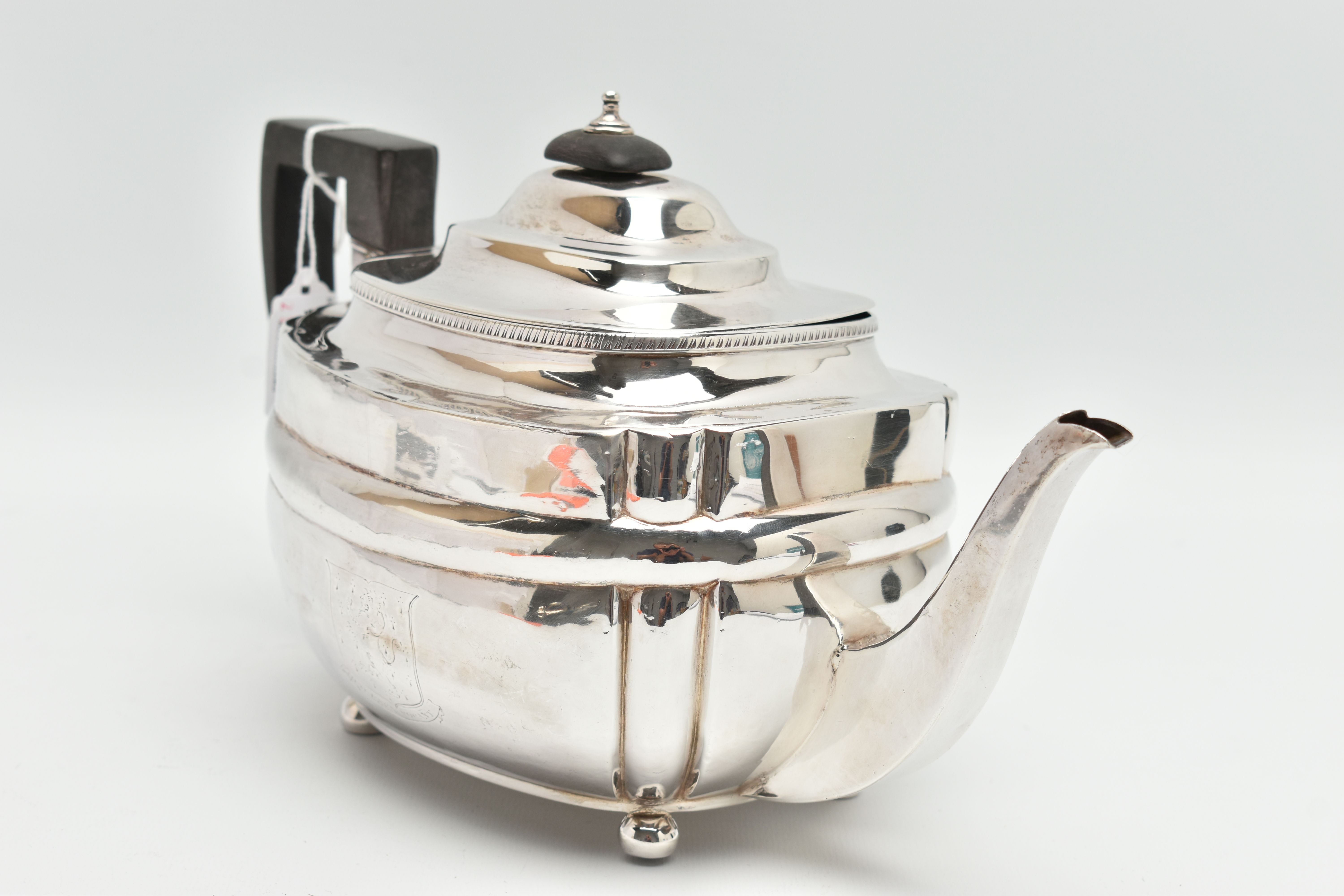 A GEORGE III SILVER TEAPOT, polished form, worn engraved crests to either side, on four ball feet, - Image 2 of 6