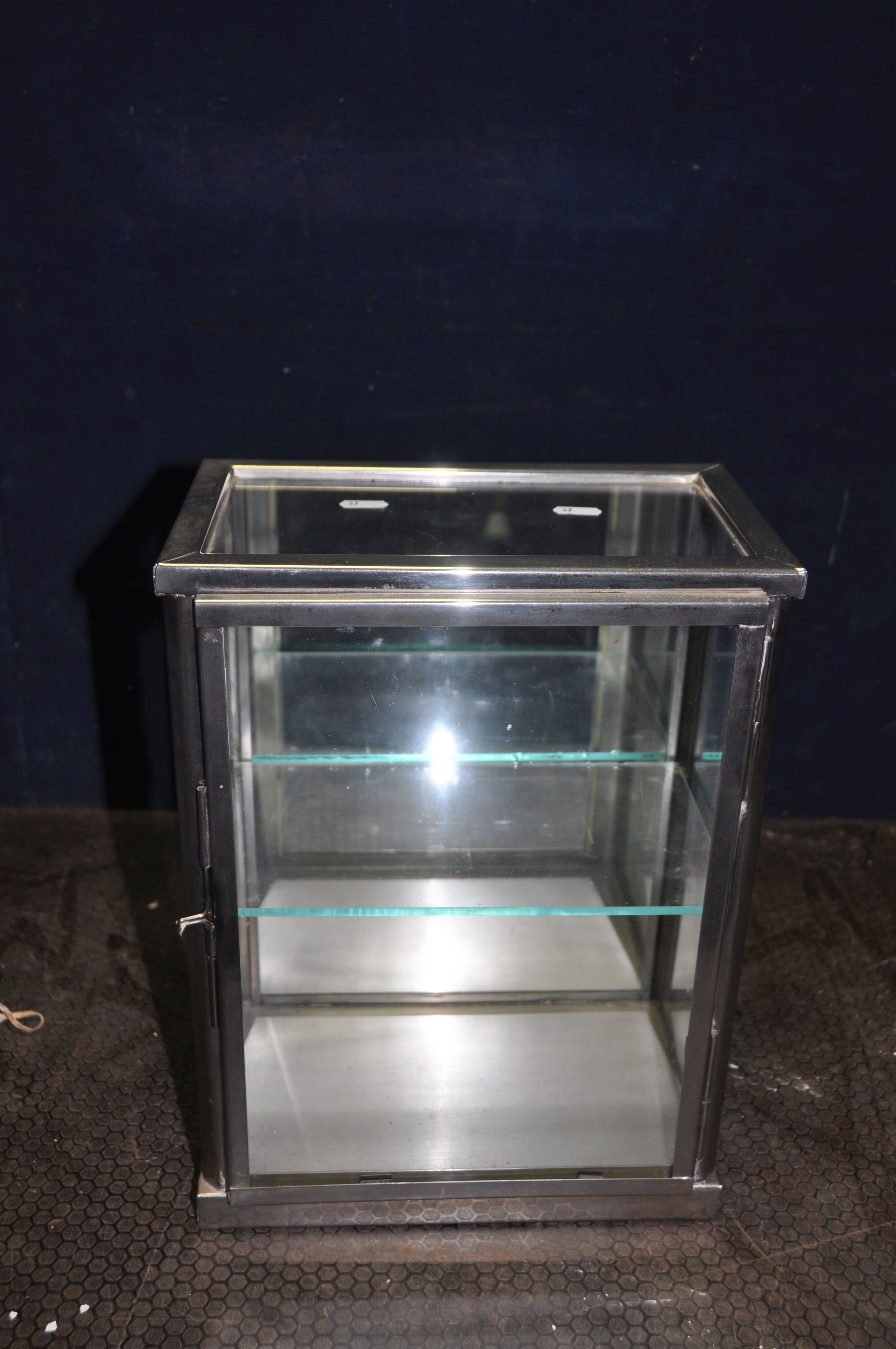 A CHROMED METAL GLASS MEDICAL/DISPLAY CABINET, with a mirrored back and single glass shelf, width