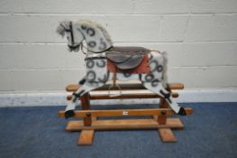 A MODERN CHILDS ROCKING HORSE, with studded leather seat and harness, on a pine frame, length 91cm x